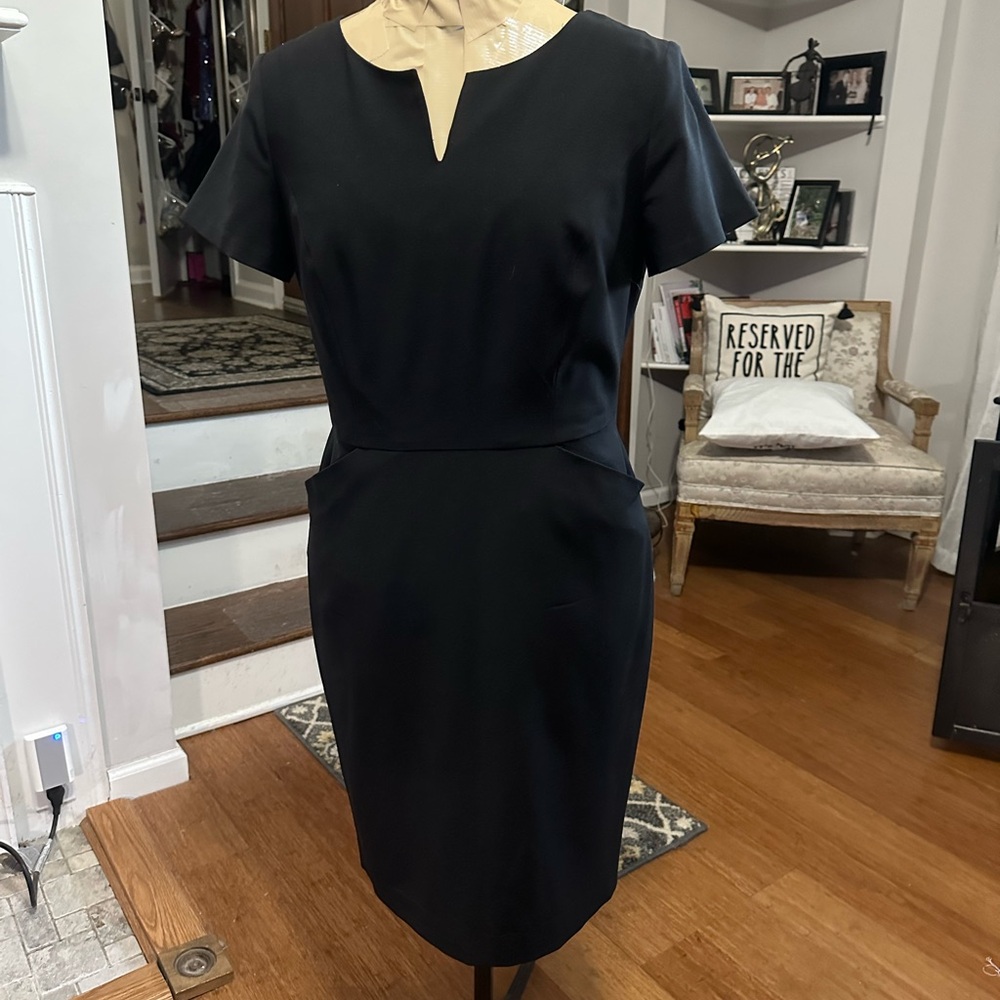 Talbots size 6P Black tailored dress with two front pockets.